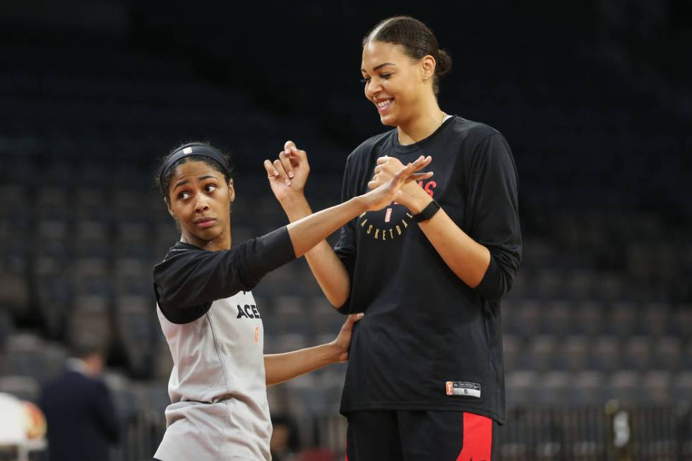 Las Vegas Aces' Sydney Colson, left, defends teammate Liz Cambage during a team practice at Man ...