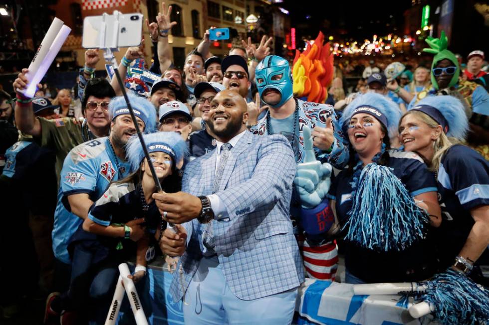 Tennessee Titans player Jurrell Casey takes a photo with fans on the main stage after announcin ...