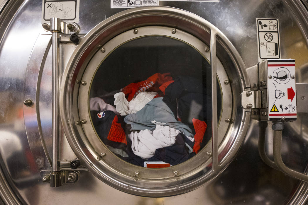 Clothing from an NBA team is washed in the laundry room beneath Mendenhall Center as basketball ...