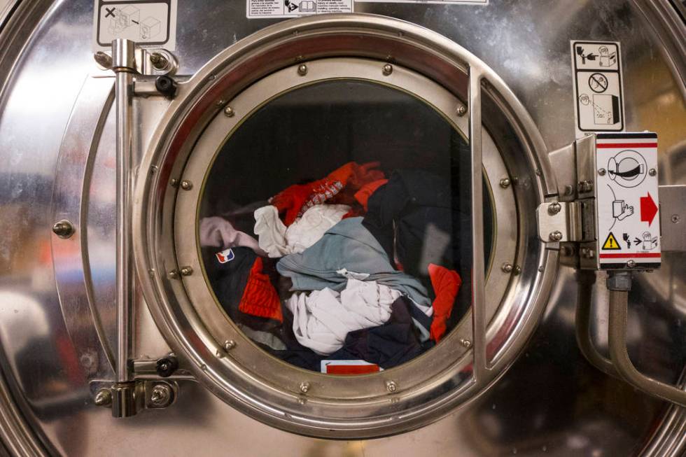 Clothing from an NBA team is washed in the laundry room beneath Mendenhall Center as basketball ...