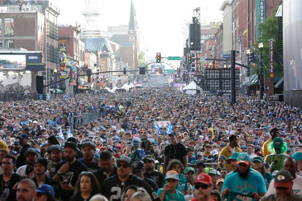 Fans stand near the main stage ahead of the second round of the NFL football draft, Friday, Apr ...