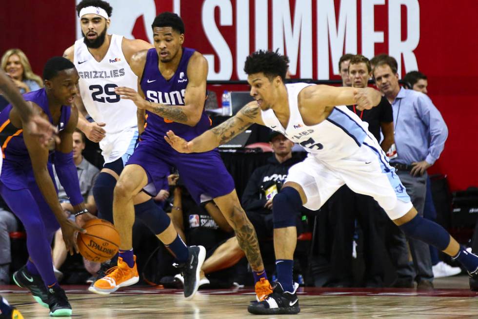 Memphis Grizzlies' Brandon Clarke, right, goes for a rebound against Phoenix Suns' Jared Harper ...