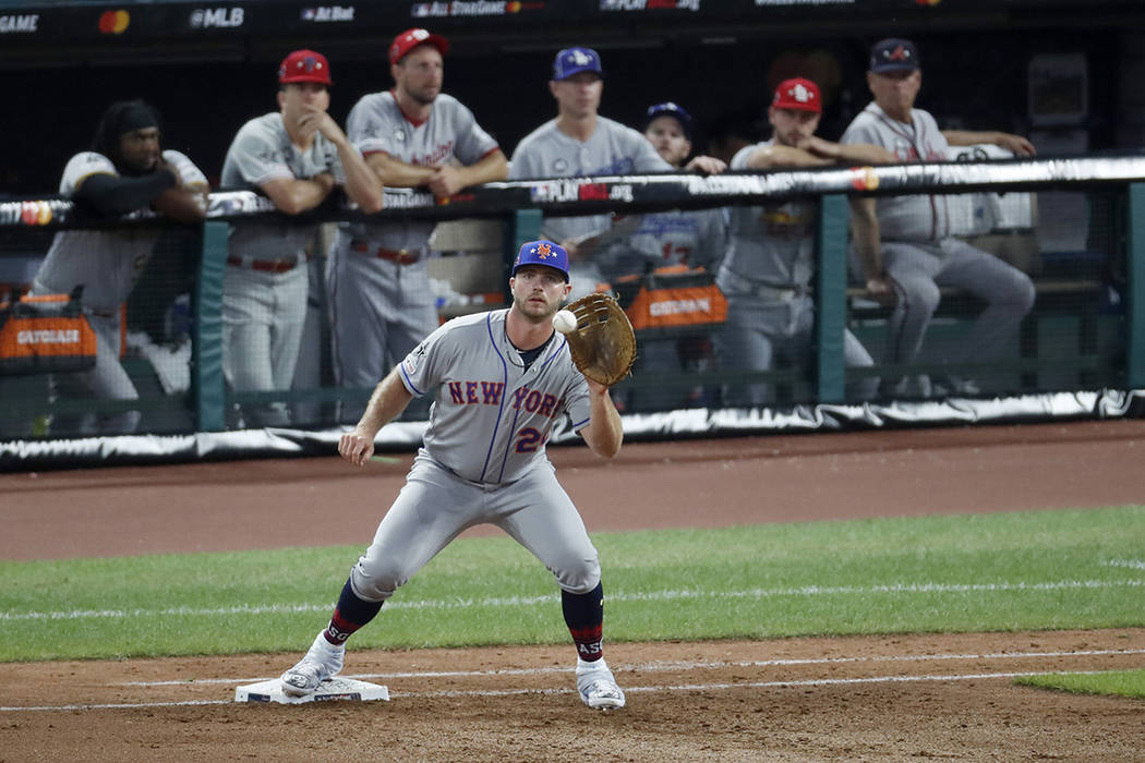 National League first baseman Pete Alonso, of the New York Mets, catches a throw from National ...