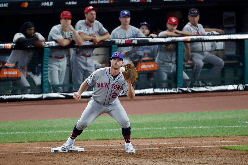National League first baseman Pete Alonso, of the New York Mets, catches a throw from National ...