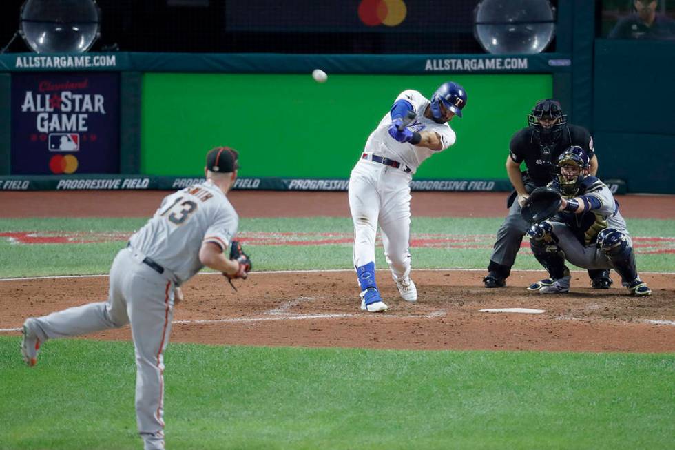 American League's Joey Gallo, of the Texas Rangers, hits a solo home run off National League pi ...