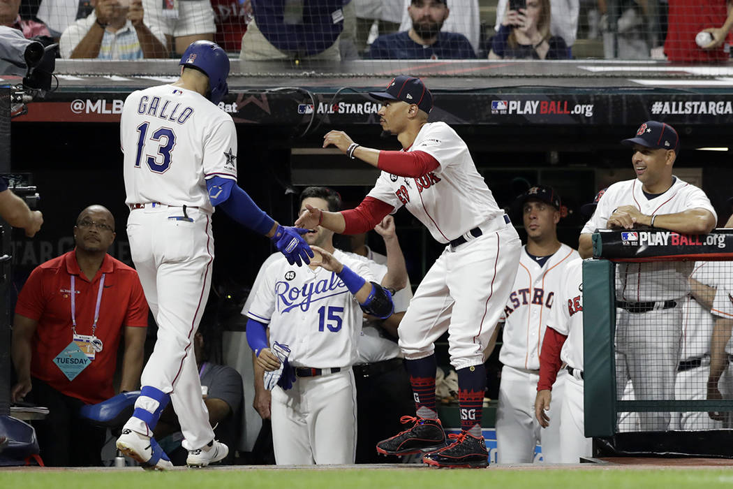 American League's Joey Gallo (13), of the Texas Rangers, is congratulated by American League te ...