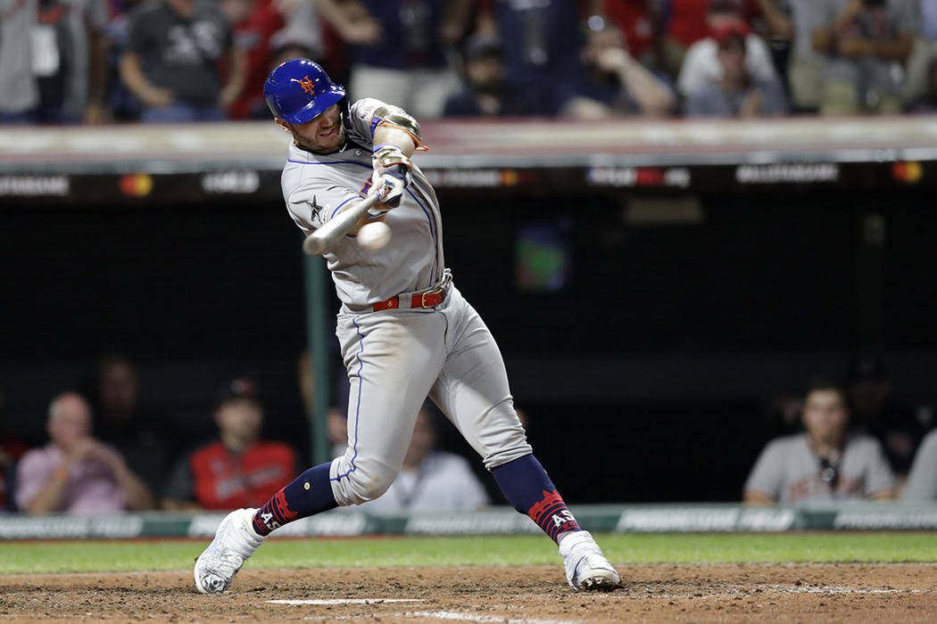 National League's Pete Alonso, of the New York Mets, hits a two run single during the eighth in ...