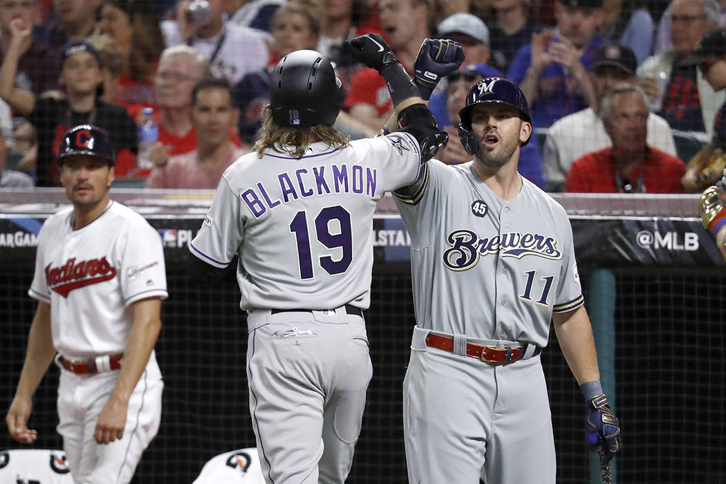 National League's Charlie Blackmon (19), of the Colorado Rockies, celebrates with National Leag ...
