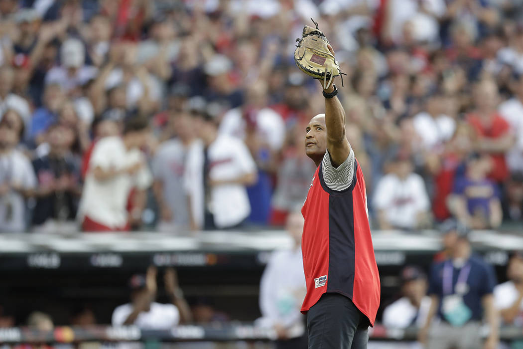 Baseball great Sandy Alomar acknowledges the fans after catching a ceremonial first pitch befor ...