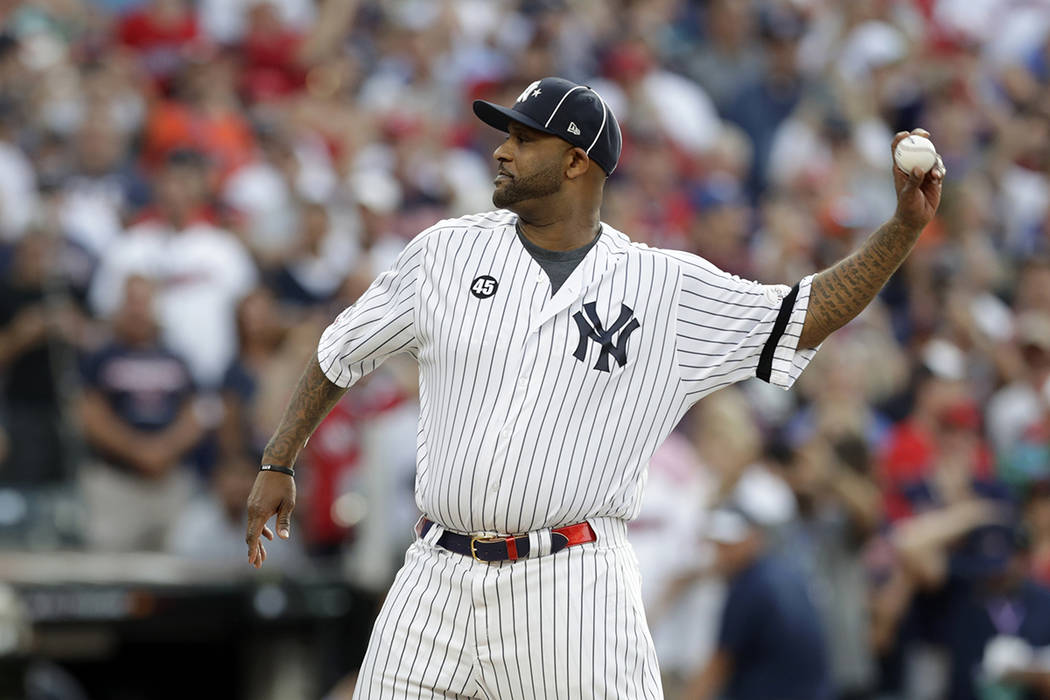 New York Yankees' CC Sabathia throws out the ceremonial first pitch before the start of the MLB ...