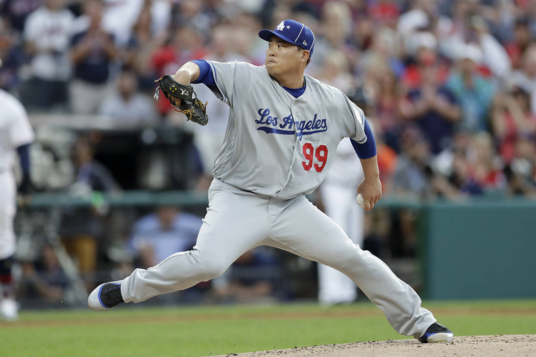 National League starting pitcher Hyun-Jin Ryu, of the Los Angeles Dodgers, throws during the fi ...