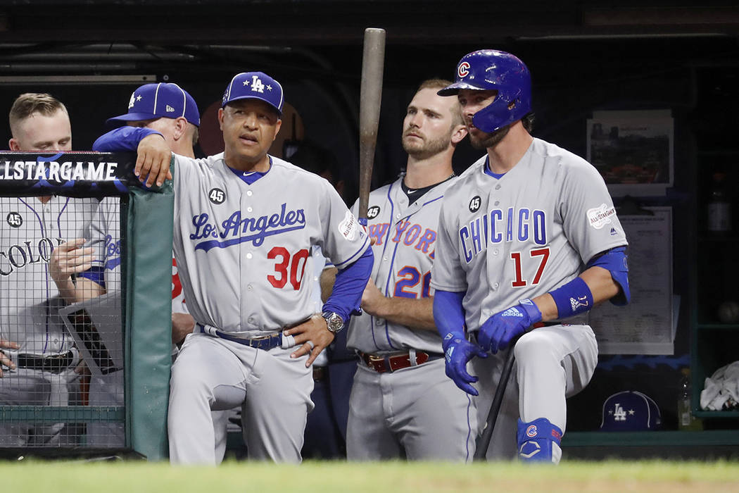 National League manager Dave Roberts (30), of the Los Angeles Dodgers, talks with National Leag ...