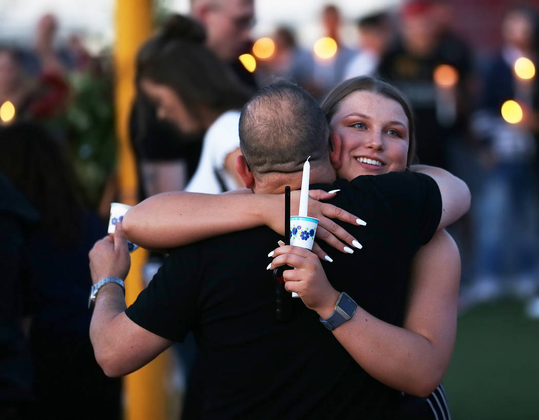 Kaelyn Moore, right, greets attendees during a vigil for Malik Noshi, a former Arbor View High ...