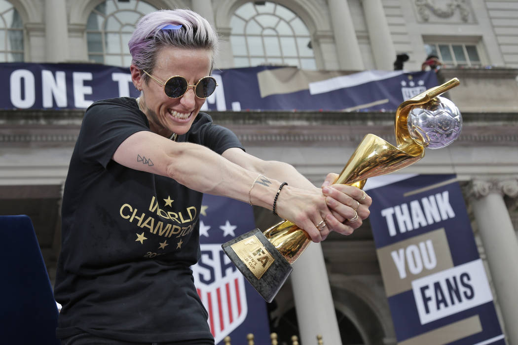 U.S. women's soccer player Megan Rapinoe celebrates with the FIFA Women's World Cup trophy at C ...