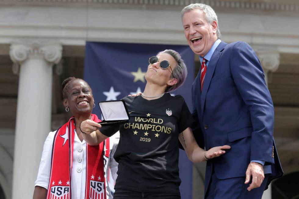 The U.S. women's soccer player Megan Rapinoe, center, poses with New York City Mayor Bill de Bl ...