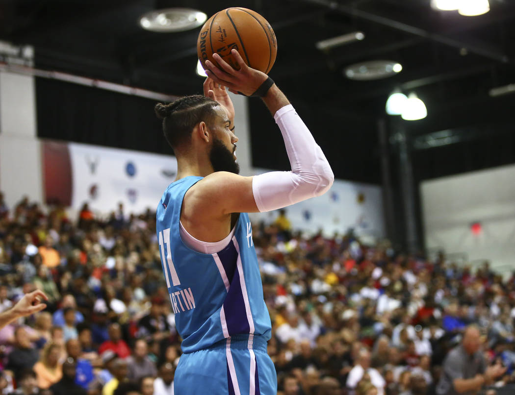 Charlotte Hornets' Cody Martin (11) looks to throw the ball in during the second half of a bask ...