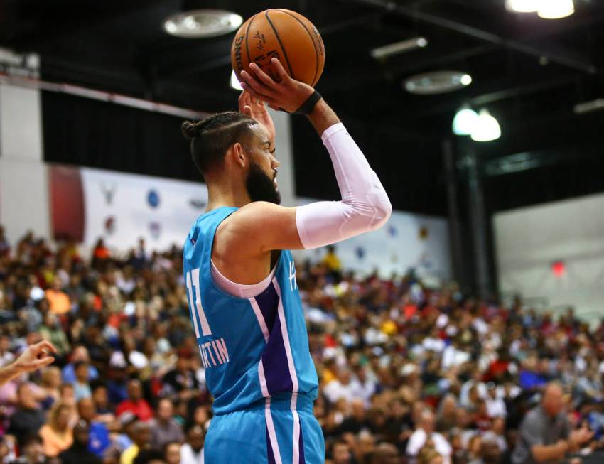 Charlotte Hornets' Cody Martin (11) looks to throw the ball in during the second half of a bask ...