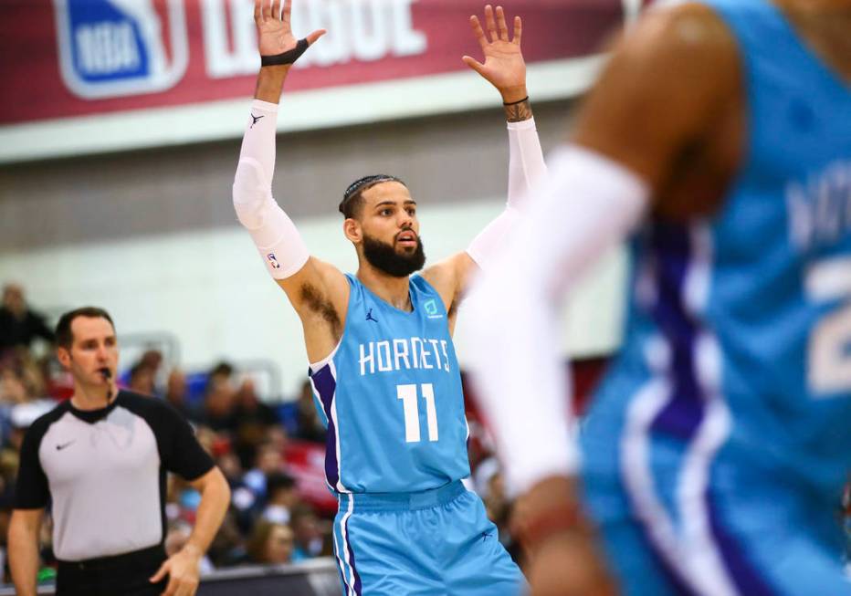 Charlotte Hornets' Cody Martin (11) motions to teammates during the second half of a basketball ...