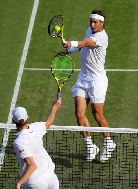 Spain's Rafael Nadal returns the ball during a men's quarterfinal match against United States' ...