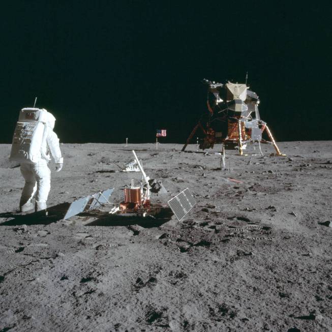 Astronaut Buzz Aldrin Jr. stands next to the Passive Seismic Experiment device on the surface o ...