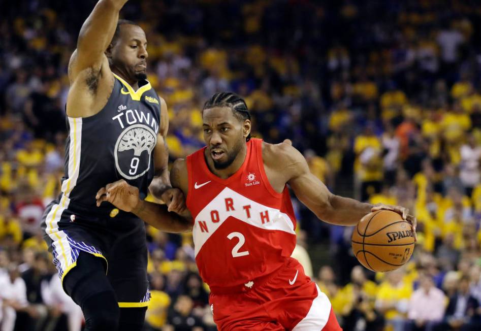 In this June 13, 2019, file photo, Toronto Raptors forward Kawhi Leonard (2) drives against Gol ...