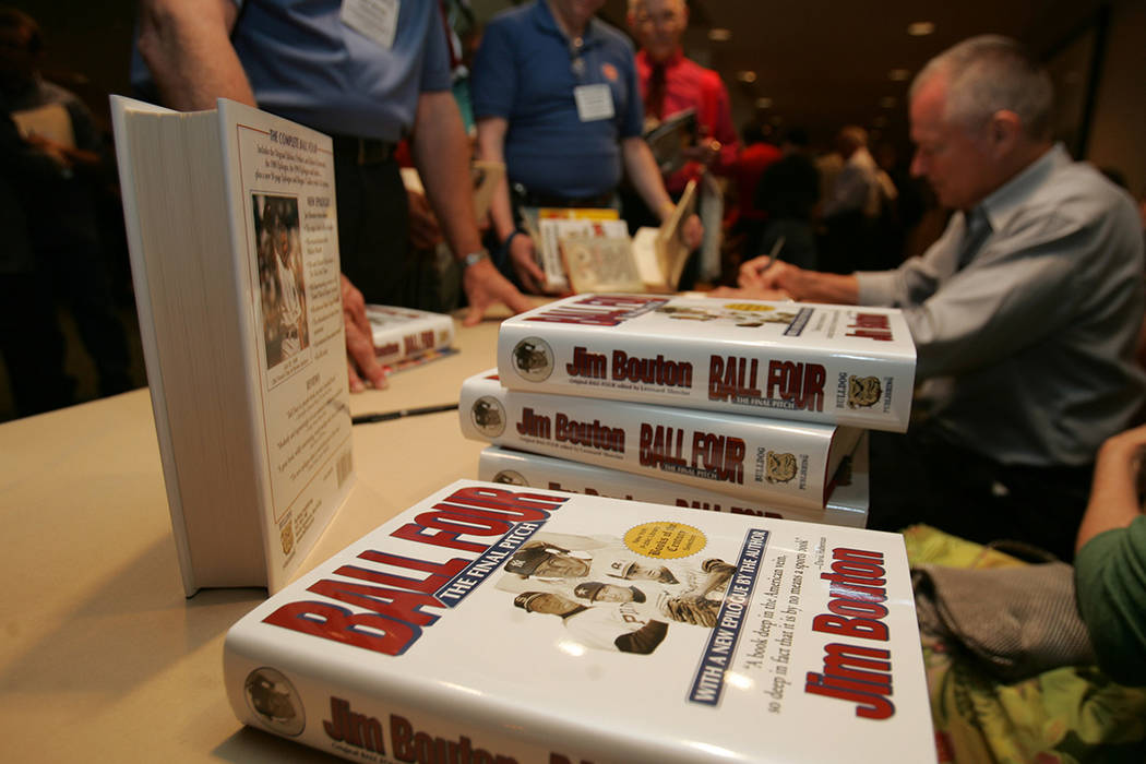 Author Jim Bouton signs his book "Ball Four," at the Society for American Baseball R ...