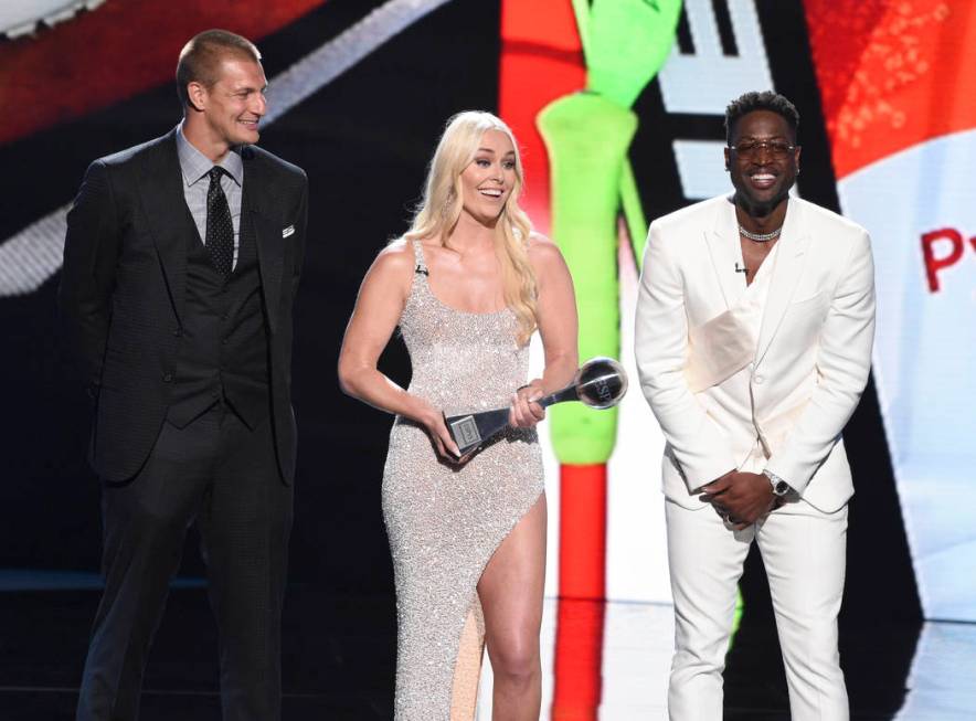 Rob Gronkowski, from left, Lindsey Vonn, and Dwyane Wade accept their awards for best moment at ...