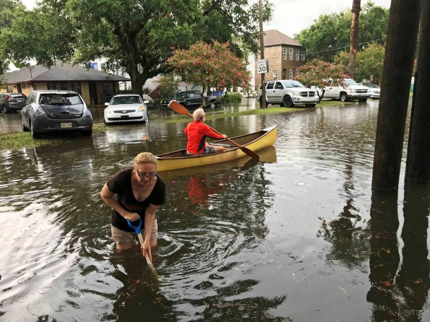 People cope with the aftermath of severe weather in the Broadmoor neighborhood in New Orleans, ...
