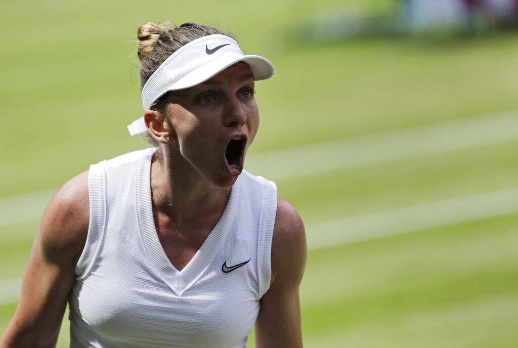 Romania's Simona Halep celebrates winning a point against Ukraine's Elina Svitolina in a Women' ...