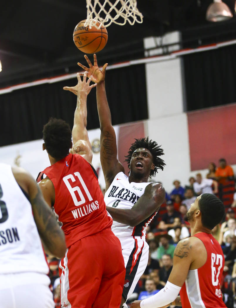 Portland Trail Blazers' Nassir Little (9) shoots over Houston Rockets' Johnathan Williams (61) ...