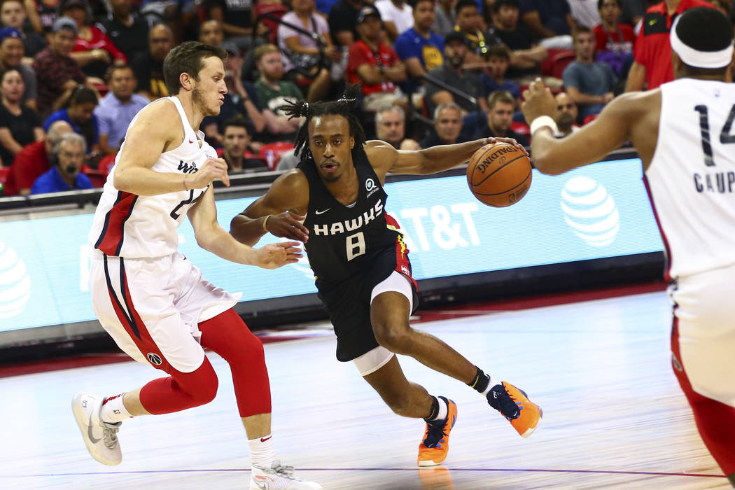 Atlanta Hawks' Tahjre McCall (8) drives to the basket against the Washington Wizards during the ...