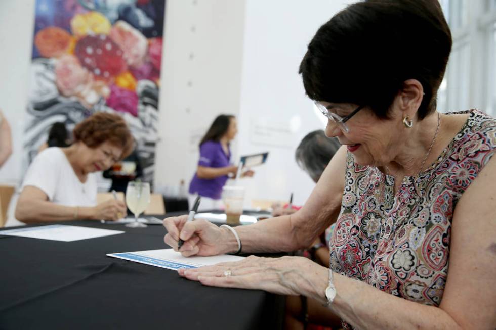 Marydean Gartrell of Henderson, writes a note for the time capsule during the 10th anniversary ...