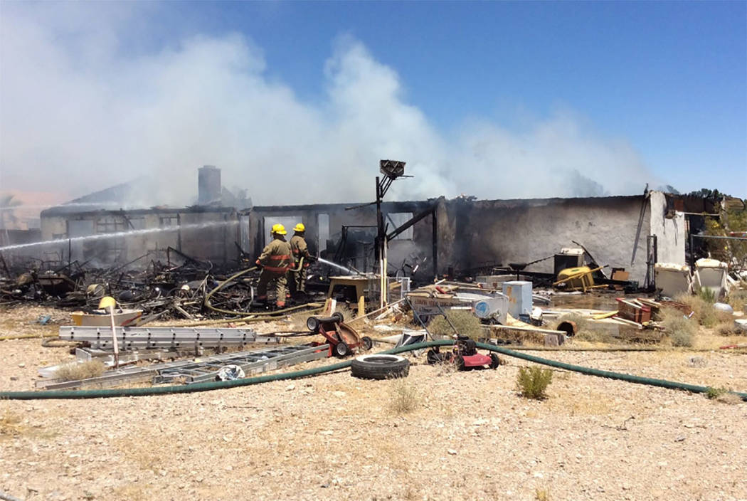 Crews battle a house fire Thursday, July 11, 2019, on the 5300 block of North Fort Apache Road ...