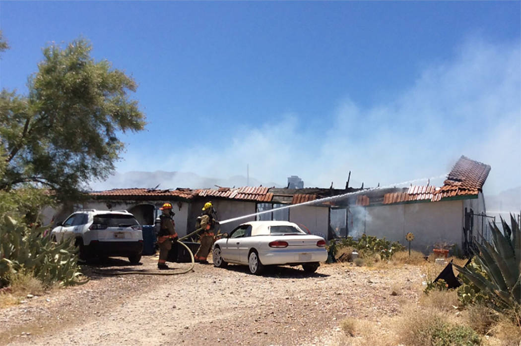 Crews battle a house fire Thursday, July 11, 2019, on the 5300 block of North Fort Apache Road ...