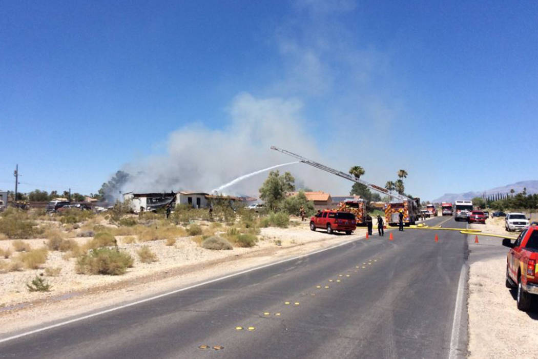 Crews battle a house fire Thursday, July 11, 2019, on the 5300 block of North Fort Apache Road ...