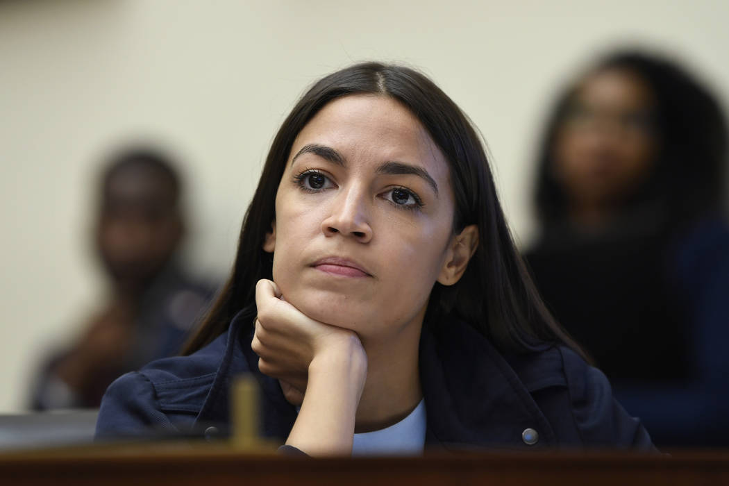 Rep. Alexandria Ocasio-Cortez, D-N.Y., listens as Federal Reserve Chairman Jerome Powell testif ...