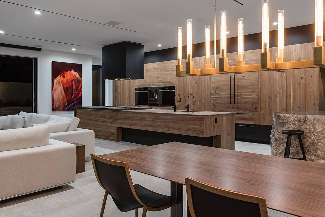 The kitchen and dining area opens to the pool area. (Jewel Homes)