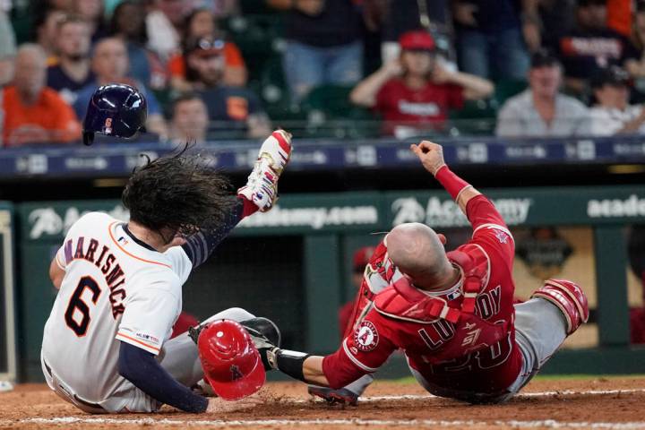 Houston Astros' Jake Marisnick, (6) collides Los Angeles Angels catcher Jonathan Lucroy (20) wh ...