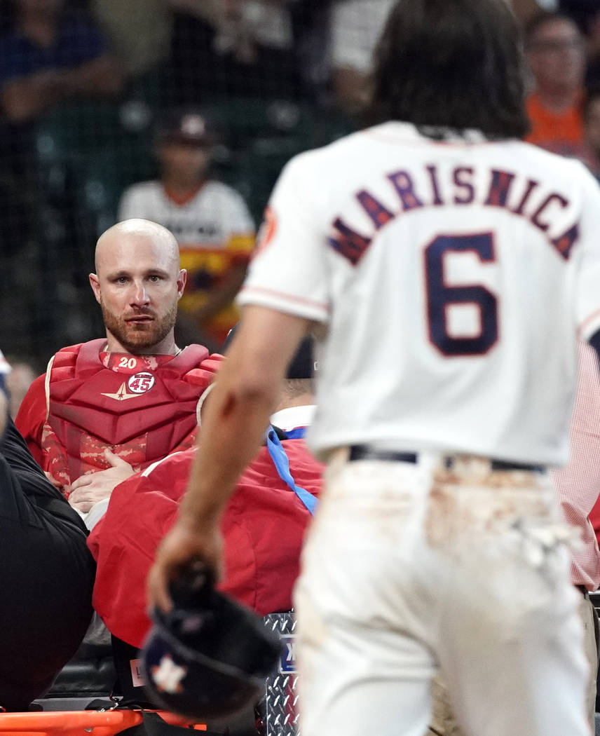Los Angeles Angels' Jonathan Lucroy, left, is carted off the field after colliding with Houston ...