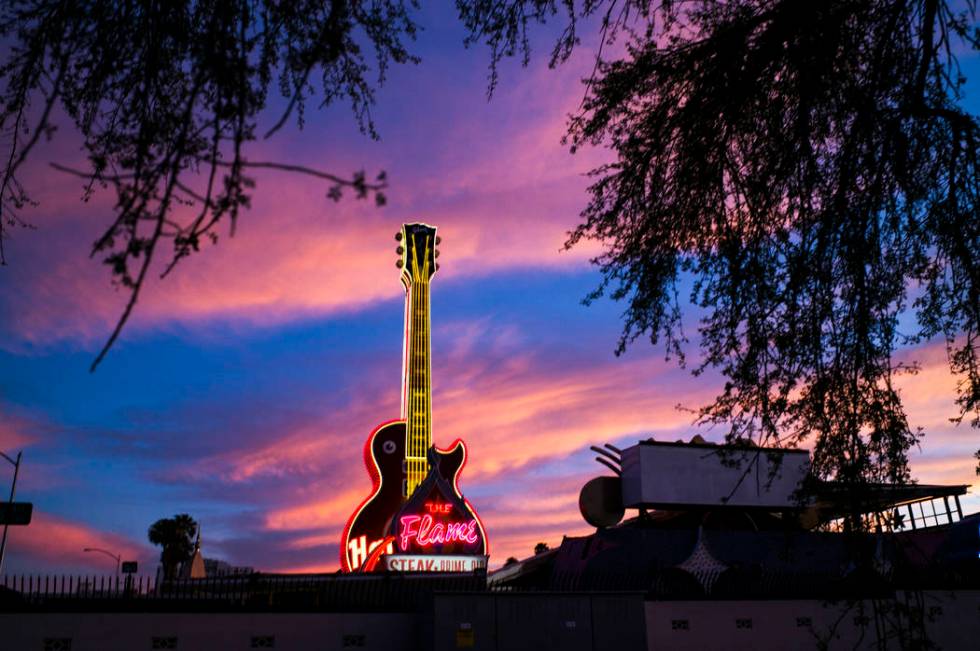 A view of the Hard Rock Cafe guitar and The Flame signs at the Neon Museum in downtown Las Vega ...