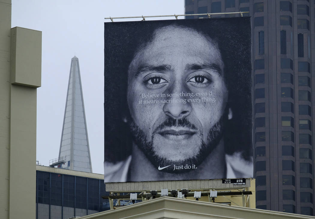 FILE - In this Sept. 5, 2018, file photo, a large billboard stands on top of a Nike store showi ...