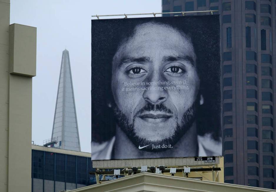 FILE - In this Sept. 5, 2018, file photo, a large billboard stands on top of a Nike store showi ...