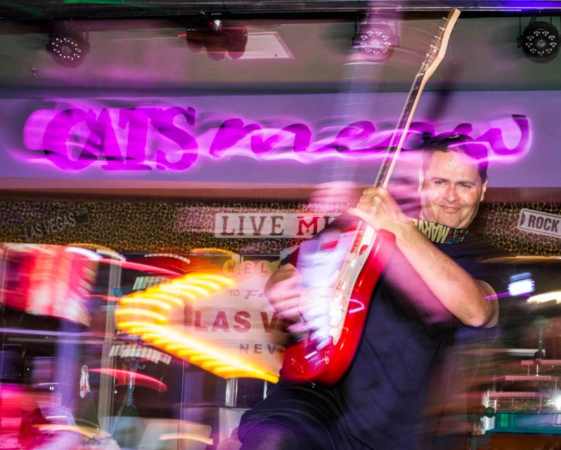 William Chrissikopoulos uses a guitar as a prop while performing at Cat's Meow karaoke club on ...