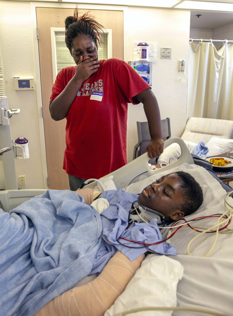 Thylicia McKnight, above, cries over her son Lennie Modica, 9, who is in recovery in the pedia ...