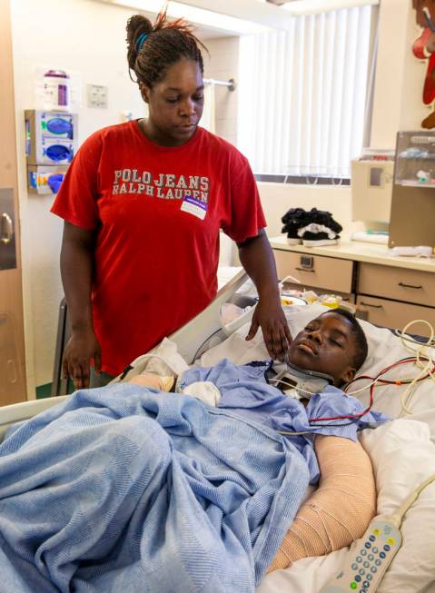 Thylicia McKnight, above, checks on her son Lennie Modica, 9, who is in recovery in the pediatr ...