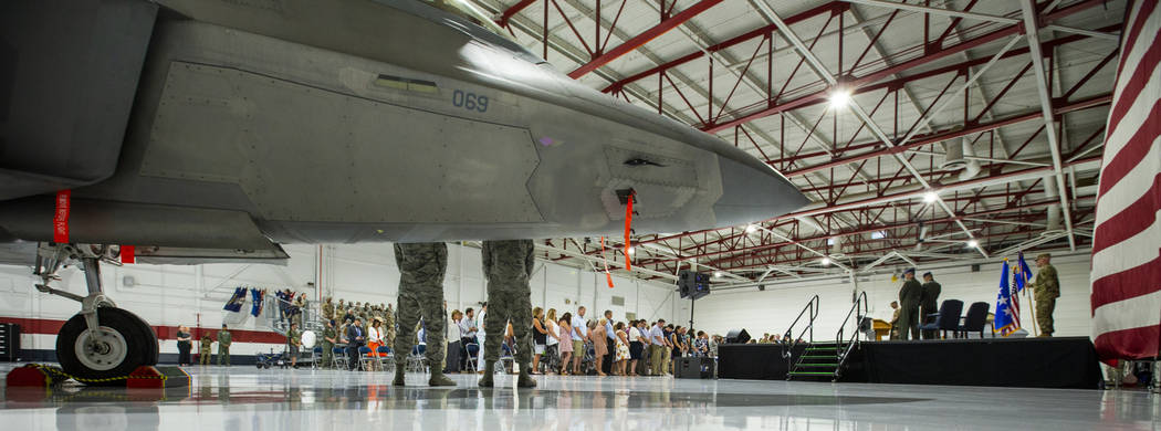 Family, friends and invited guests stand during the Assumption of Command Ceremony for Maj. Gen ...