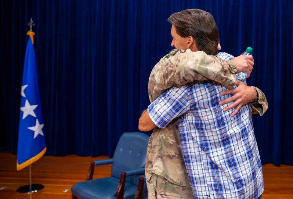 Staff Sgt. Kenneth DeLongchamp, left, hugs his father Ken at Nellis Air Force Base on Friday, J ...