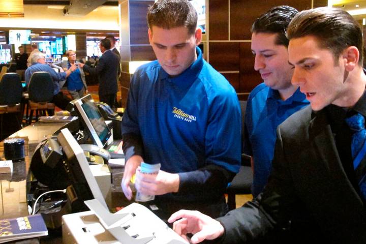 Employees at the sports book at the Tropicana casino in Atlantic City, N.J., count money moment ...