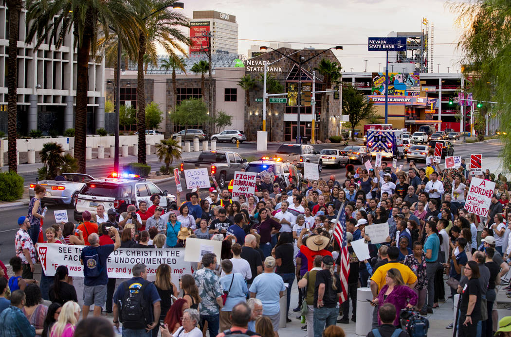 Advocates, activists and impacted persons gather for protest chants during Lights for Liberty: ...