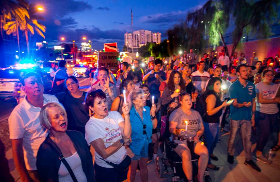 Advocates, activists and impacted persons hold lit candles and yell protest chants during Light ...